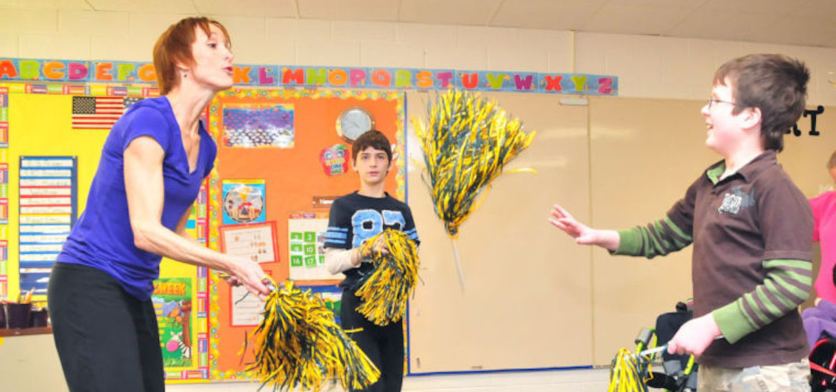 Teacher Lisa Moulton and students Jared West and Jacob Barnhart perform a movement to portray falling leaves (photo: John Halley/Athens Messenger)