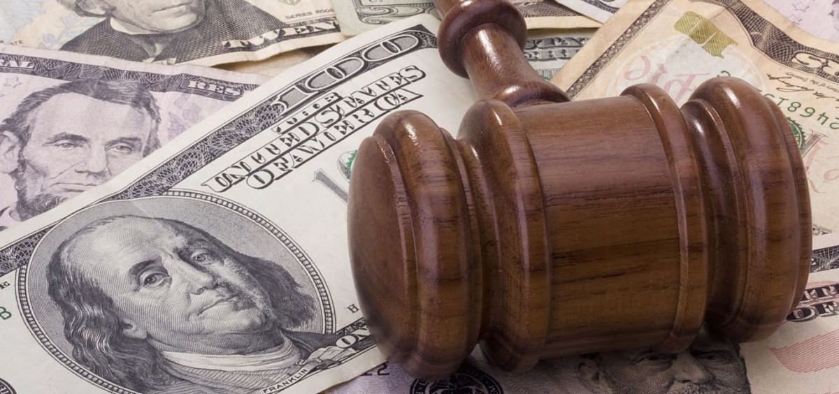 A gavel lays on top of money