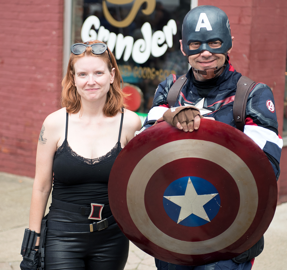 A man dressed as Captain America and a woman dressed as Black Widow from the Marvel Avenger’s series pose for pictures at the Mothman Festival in Point Pleasant, W. Virgina on Saturday, Sept. 19, 2015. (Jeffrey Zide/WOUB)