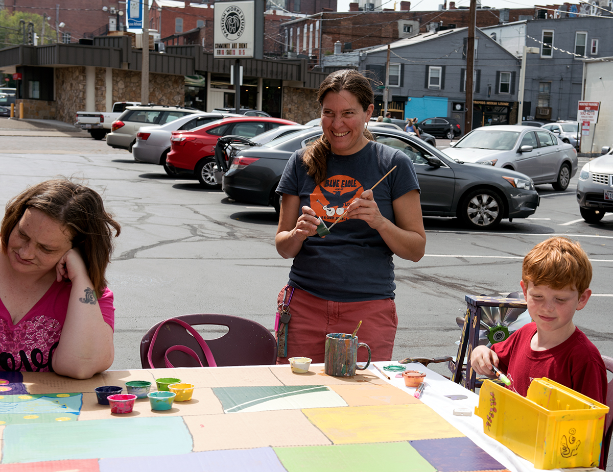 Marilyn Tucker(left), Amy Lipka(center), and her grandson Max(left) work on painting makeshift bricks during the Passion Works Summer Bash at the Passion Works studio on West State Street in Athens, Ohio on Saturday, September 19, 2015. The makeshift bricks will be displayed at the homecoming parade later this year.