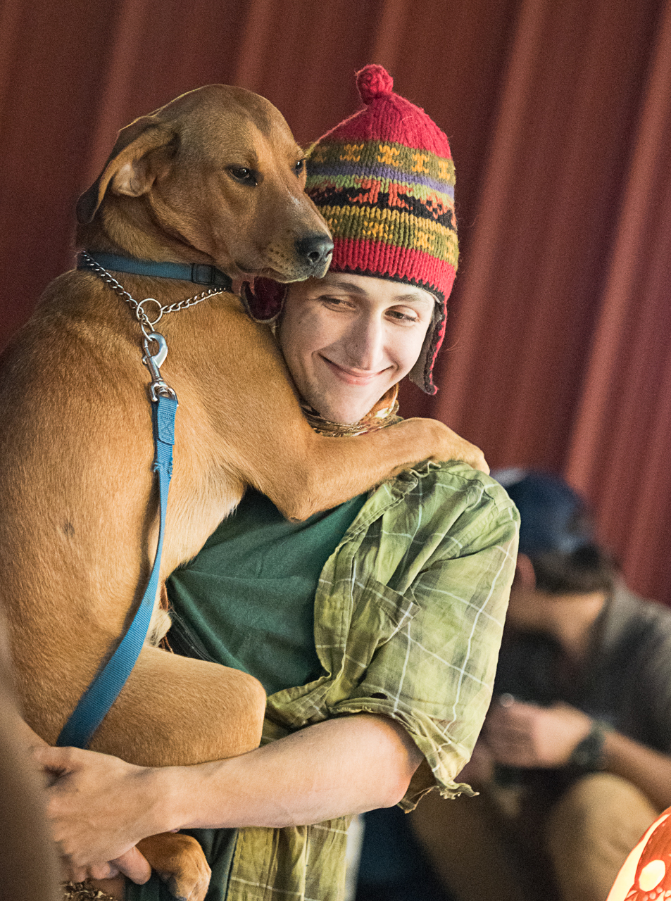 Nigel Wilson, a recent Ohio University math education graduate, dances with his shelter dog Rigbey to the music of Bright @ Night at Jackie O’s Brewery on October 25, 2015. (Robert McGraw/WOUB)