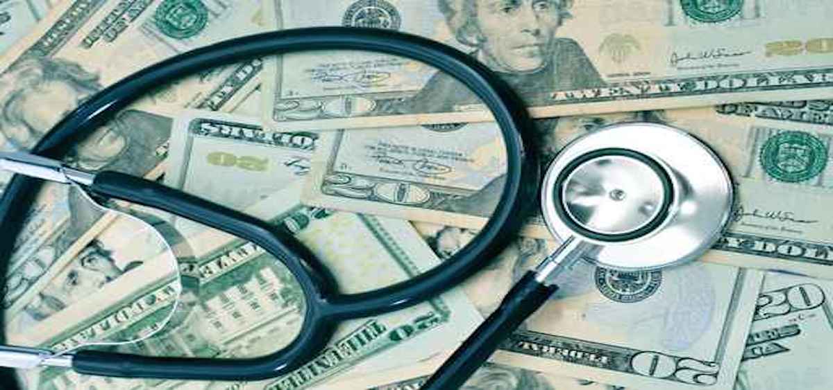 A graphic has a stethoscope on money. It is trying to depict health insurance.