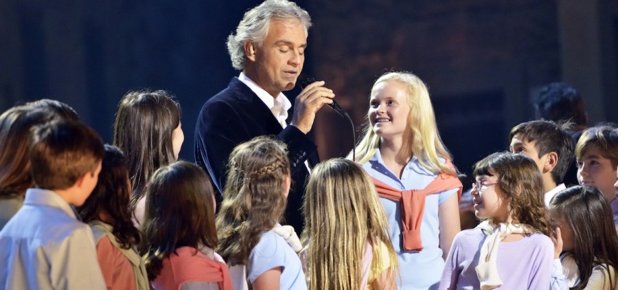 Andrea Bocelli singing with children on stage