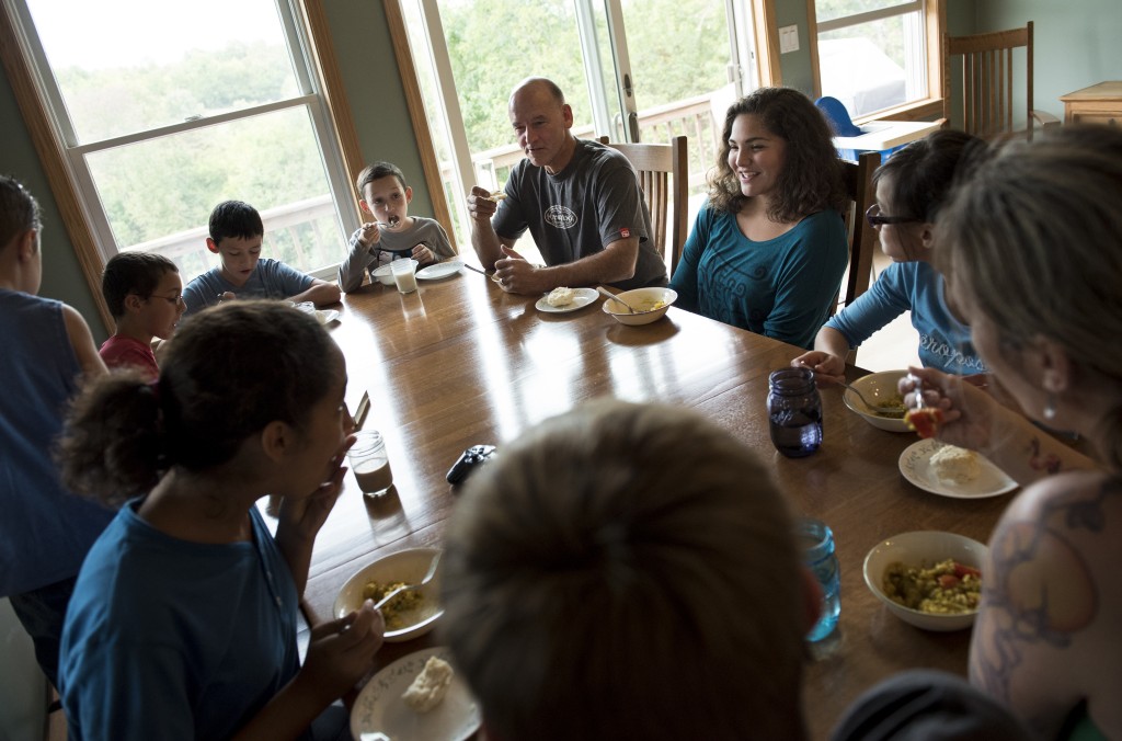 The Fullers sit down to dinner at their home in Athens, Ohio, where they moved from there home state of Oregon to start fresh for their eight children, seven of whom are adopted.