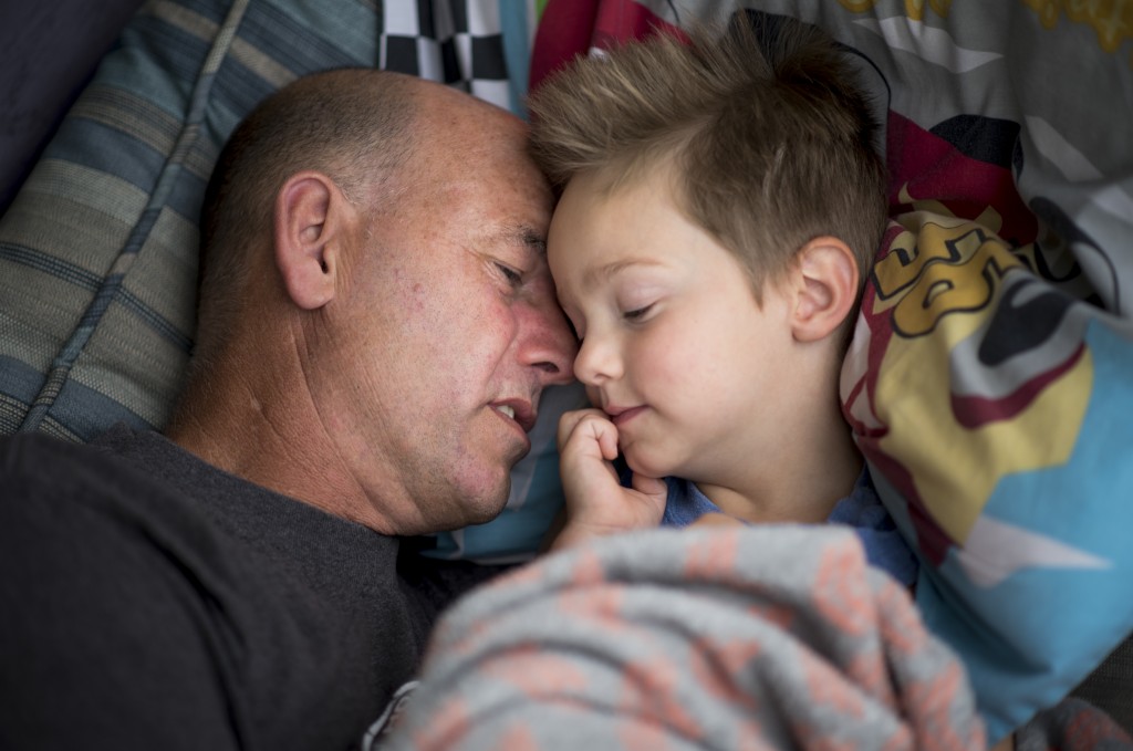 Lyle whispers to his adoptive son Levi to fall asleep as they take an afternoon nap together on their front porch. Levi was born to a mother addicted to heroin, methamphetamine, alcohol, and marijuana and as a result was declared medically fragile with failure to thrive.