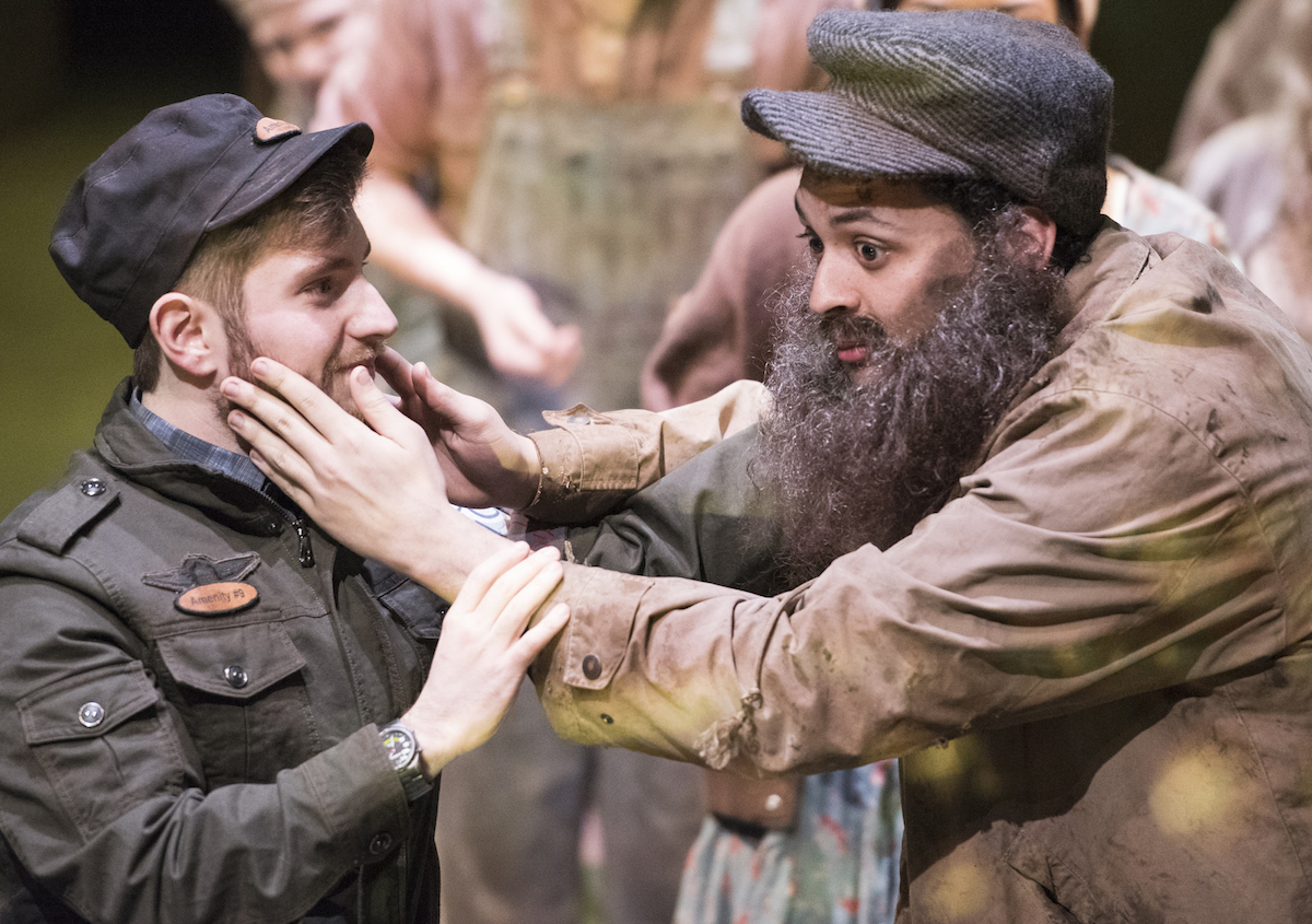 Bobby Strong (Jarahme Pollock, left) calms his father Old Man Strong (Tyler Tanner), who cannot afford his urinal admission for the day. For his disobedience his father is sent to the not-so-understood land “Urinetown.” (Robert McGraw/WOUB)