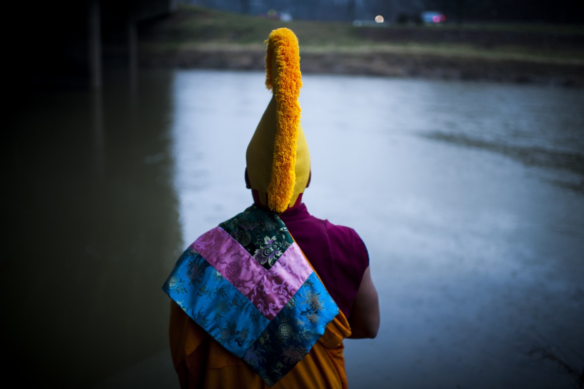 Athens, Ohio- Tibetan monks gather along side of the Hawking River to complete the ceremony of the mandala that was created to represent the idea that nothing in life is permanent. Most of the ceremony was held on the fourth floor of Baker Center at Ohio University on March 10, 2016. (MICHAEL SWENSEN FOR WOUB)