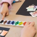 Area children finger paint at a recent Family Art Encounters workshop at the Kennedy Museum of Art. (Robert McGraw/WOUB)