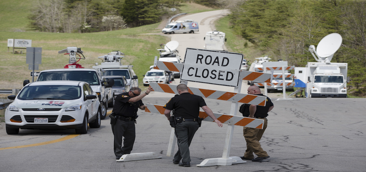 Authorities set up road blocks at the intersection of Union Hill Road and Route 32 at the perimeter of a crime scene, Friday, April 22, 2016, in Pike County, Ohio.