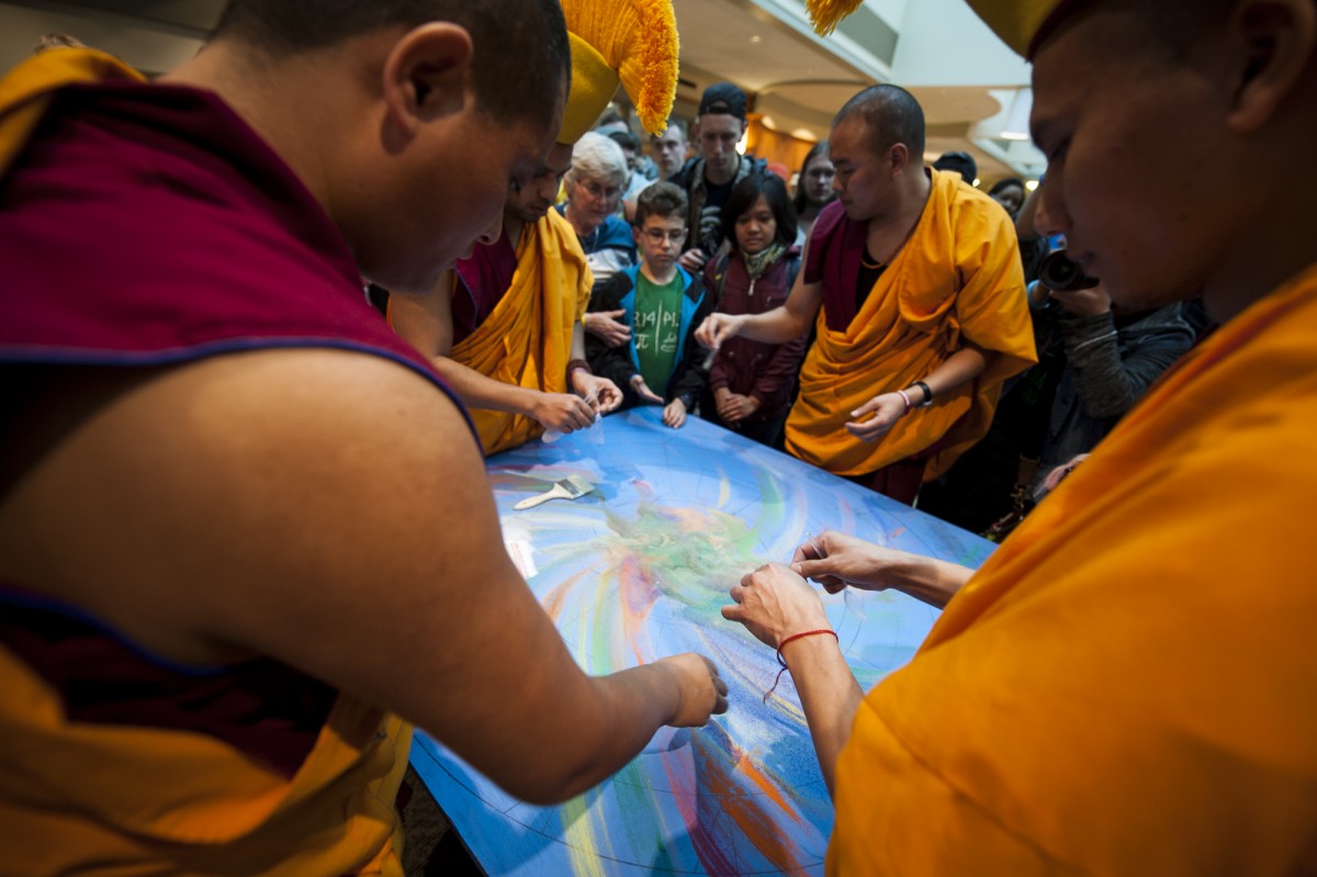 Athens, Ohio- Tibetan monks bag up some sand that was used to complete the mandala that was created on the fourth floor of Baker Center at Ohio University on March 10, 2016. (MICHAEL SWENSEN FOR WOUB)