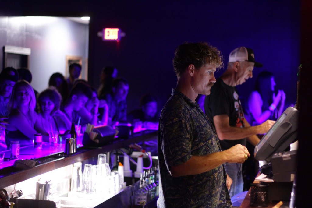 Bartenders tend to the needs of a busy bar on the last night of Blackoutfest '16. (WOUB/ Joe Votaw)