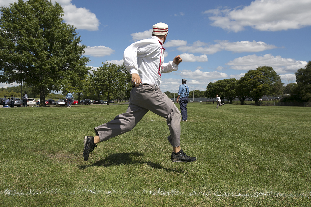 Ohio Village Muffins player Evan Lee runs to first during a vintage baseball game against the Addison Mountain Stars at the Ohio Cup vintage baseball games in Columbus on Saturday. (WOUB/Jennifer Coombes)