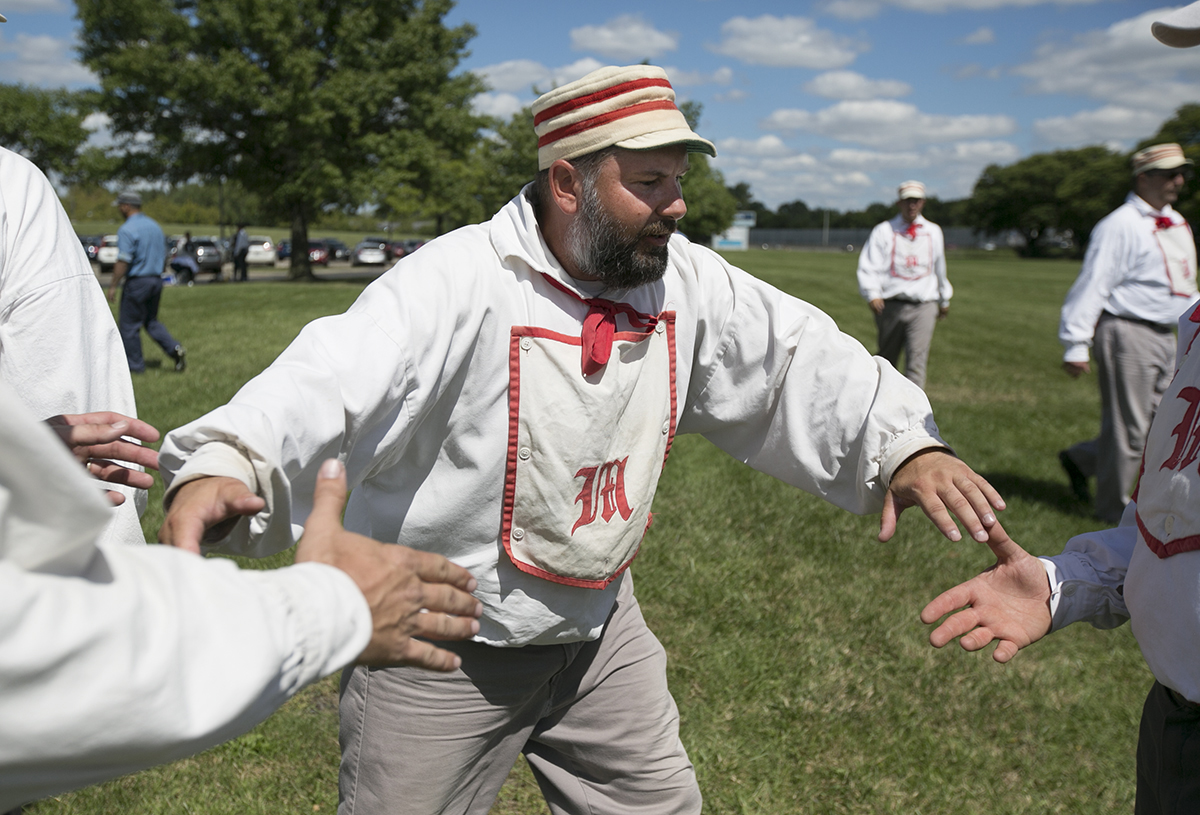 Robert “Tripp” Daily shakes hands with this Ohio Village Muffins teammates after a win on Saturday at the Ohio Cup vintage baseball games. (WOUB/Jennifer Coombes)
