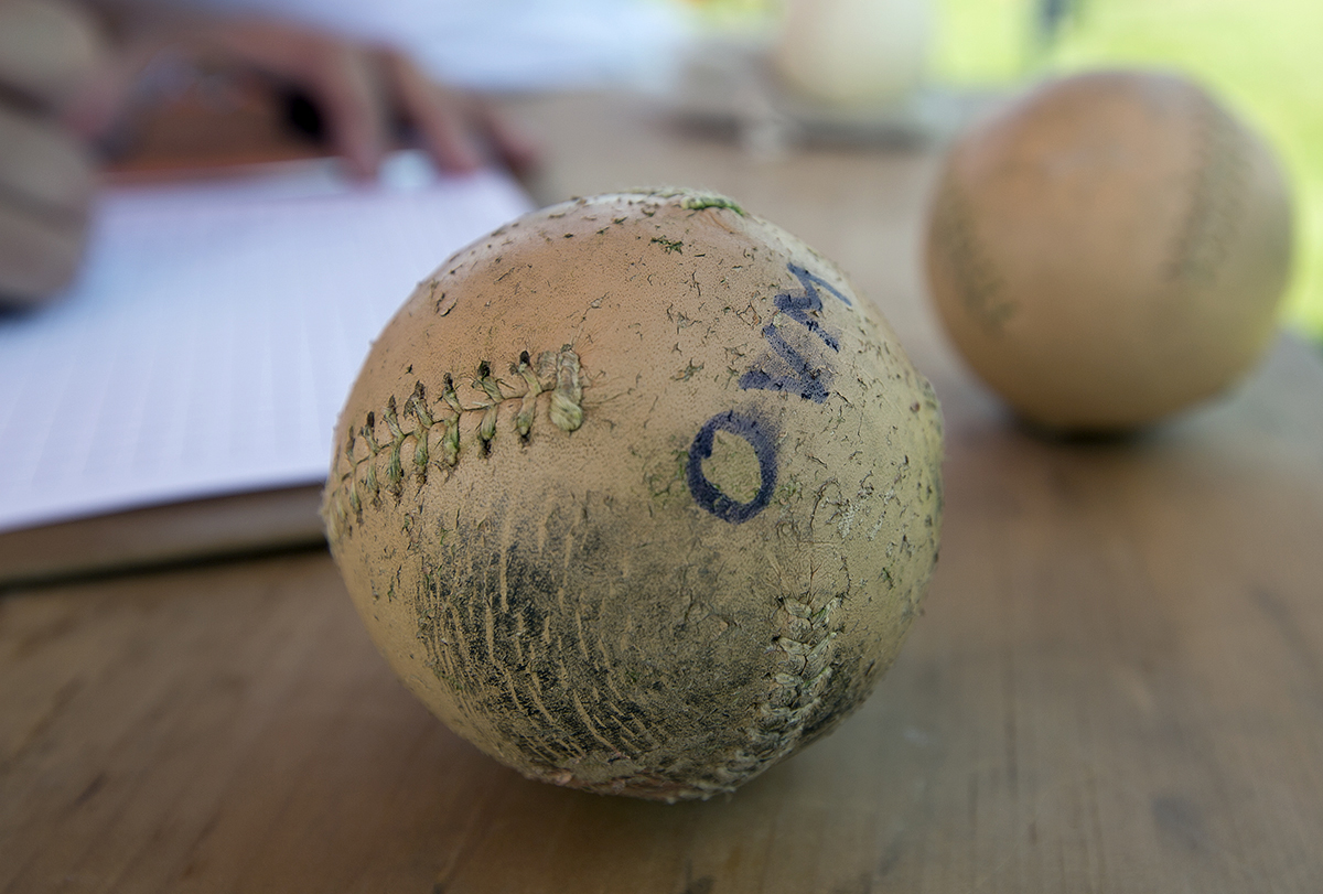 Vintage-style baseballs are used as a part of the vintage baseball leagues’ commitment to the first standards and practices of basebasell. The Ohio Village Muffins (OVM) use wooden bats, grassy fields, no mitts and old-style rules for the game. (WOUB/Jennifer Coombes)