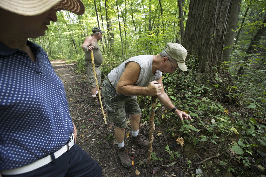 Dixie Bosworth, left, Steve Downour, center, and Earl Downour search for mushrooms during Saturday’s Mushroom Hike offered by Lancaster Parks and Recreation. (WOUB/Jennifer Coombes)