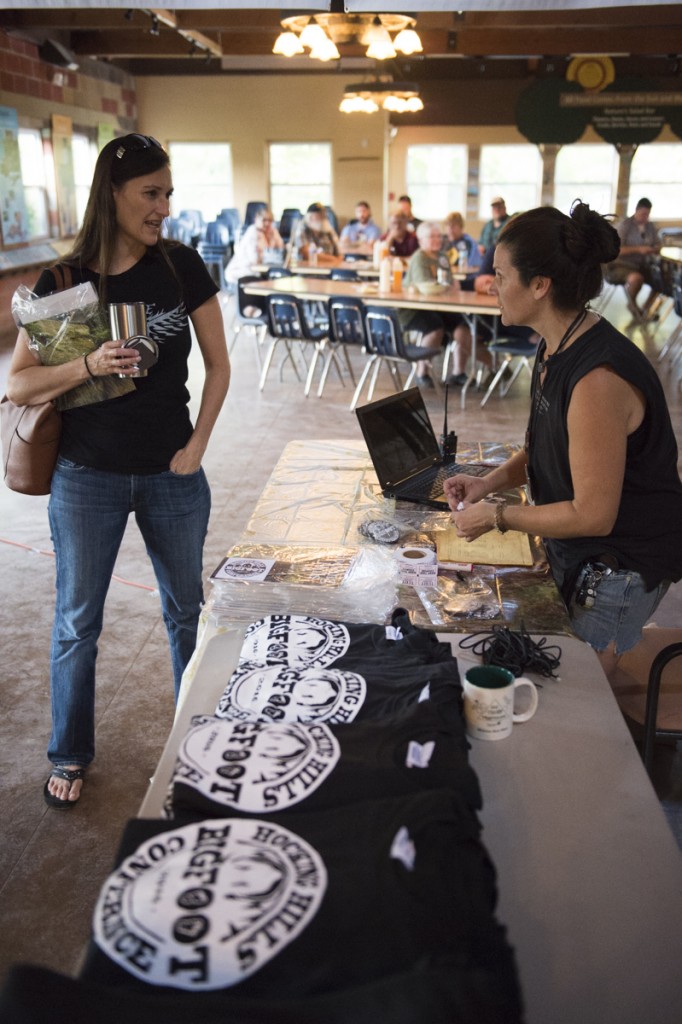 Wife of speaker Charlie Raymond (l), Dana Raymond checks in with Bea Mills (r)  at the 2016 Hocking Hills Bigfoot Conference on September 23, 2016. (Robert McGraw/WOUB)