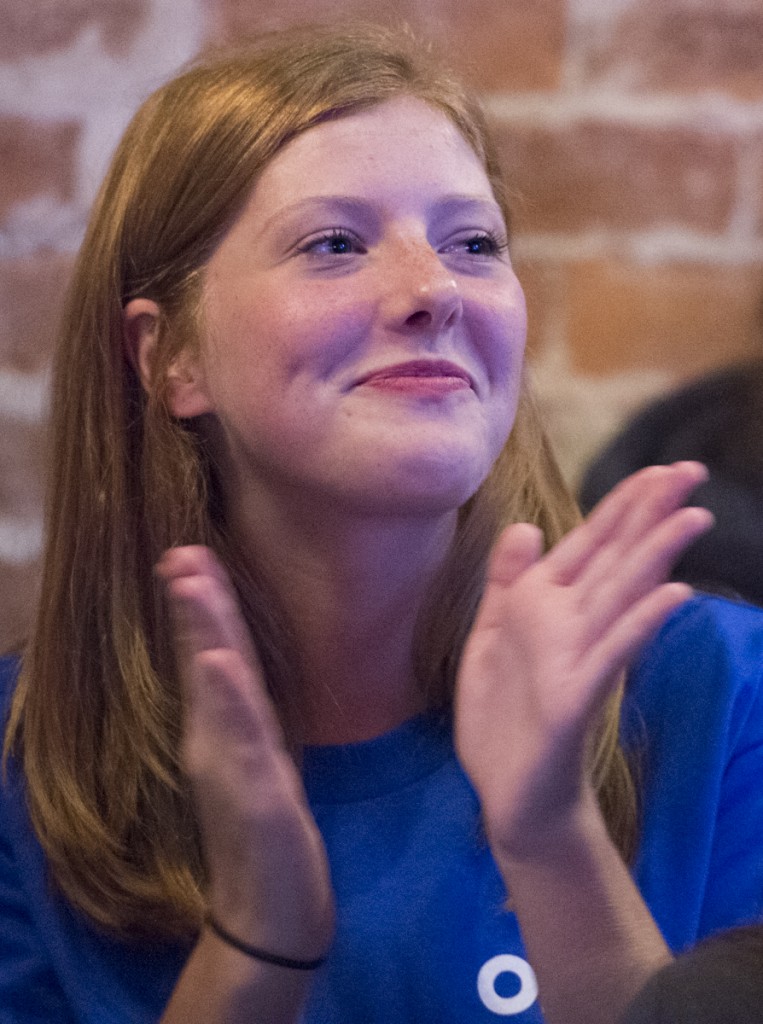 Ashley Fishwick applauds Hillary Clinton’s response to Donald Trump’s attack on her record during the Debate Party held at the Pigskin Bar and Grille in Athens, Ohio, on September 26, 2016. “I am a Hillary supporter because she stands for what she believes in,” said Fishwick. “Trump talks rhetoric. He doesn’t support women and minorities and Hillary cares about the issues and wants to make this country a better place. I don’t see a reason I shouldn’t support her.” (Robert McGraw/WOUB)
