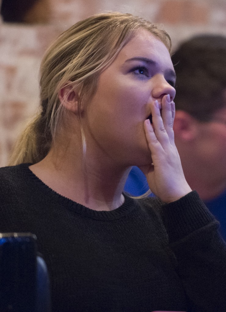 Chloe Szakovits intensely watches the debate between Hillary Clinton and Donald Trump on September 26, 2016, at the Pigskin Bar and Grille in Athens, Ohio. (Robert McGraw/WOUB)