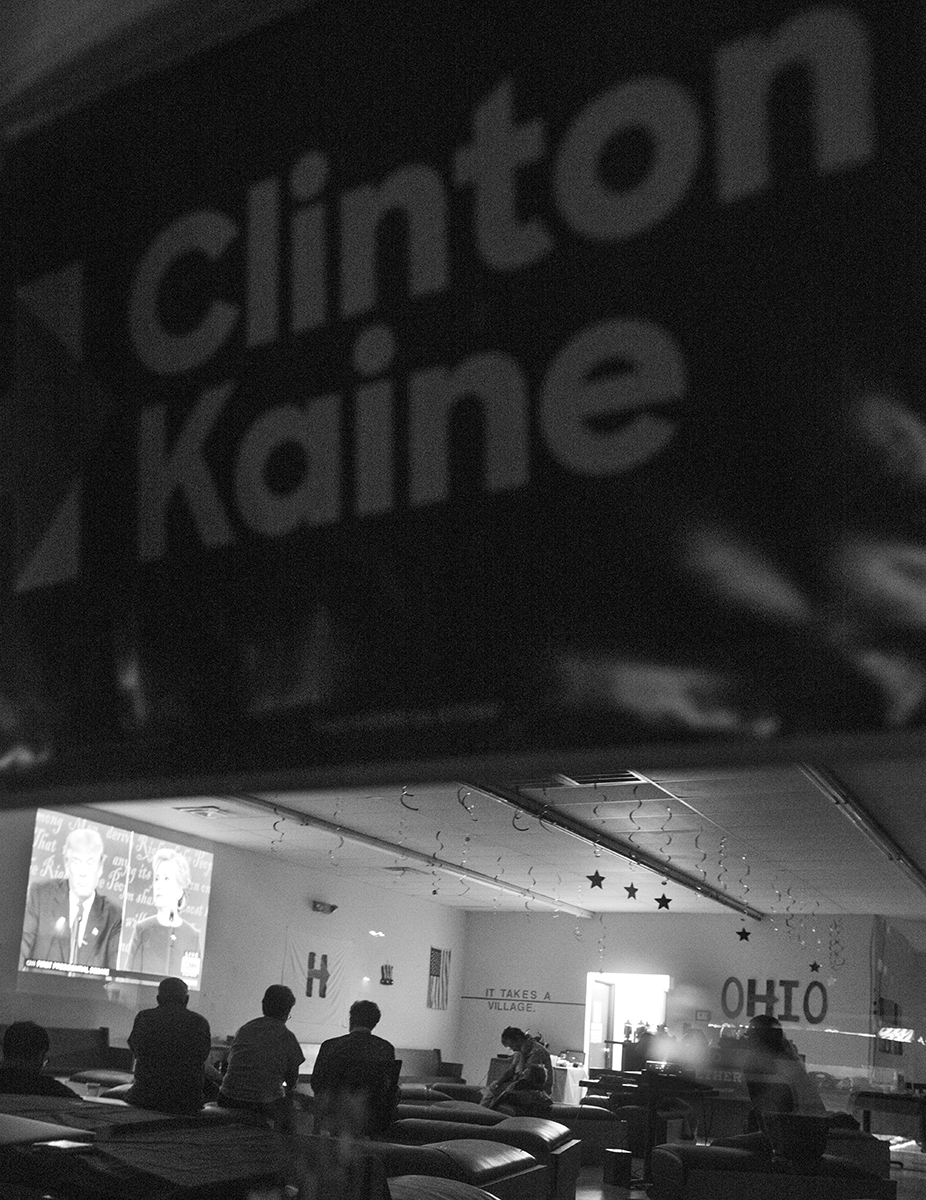 Democratic presidential support posters hang in the window at a gathering of Clinton voters while the first presidential debate is projected on a wall on Monday, Sept., 26, 2016 at 1154 E Canal Street in Nelsonville, Ohio. (Kelsey Brunner/WOUB)