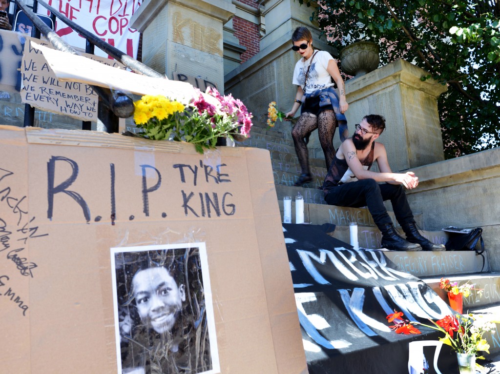 Mary Baxter, left, and Jack Opal join the memorial of Tyre King on the Athens County Municipal Courthouse steps on Wednesday, September 21, 2016 in Athens, Ohio. The African American 13-year-old, Tyre King, was shot and killed by police officers earlier this month in Columbus, Ohio. (Kelsey Brunner/WOUB)