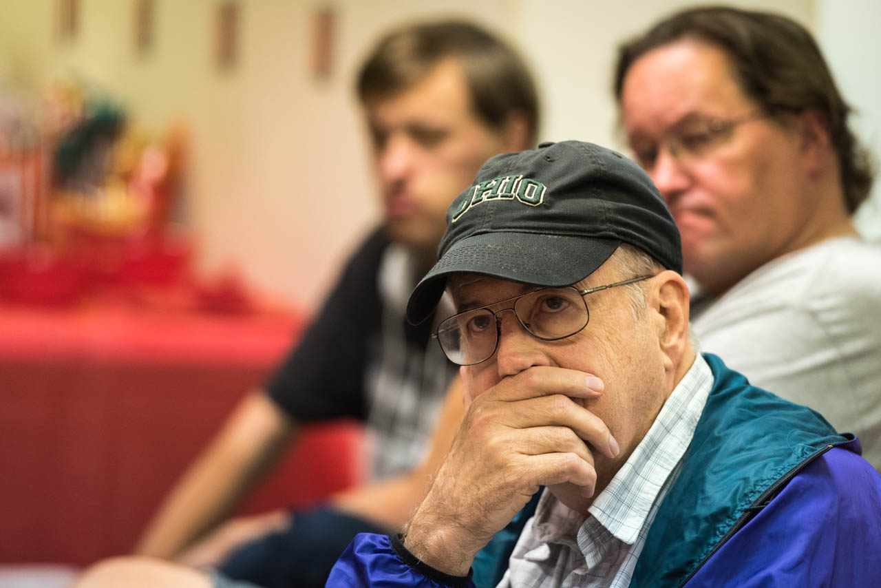 Carl Denbow of Athens, Ohio listens to Donald Trump and Hillary Clinton debate during the first of three presidential debates. Denbow along with (from left to right) Alex Wilson and Todd Wilson, both of Albany, Ohio, watched the debate at the Athens County Republican headquarters on September 26, 2016 in Athens, Ohio. (Atish Baidya/WOUB)