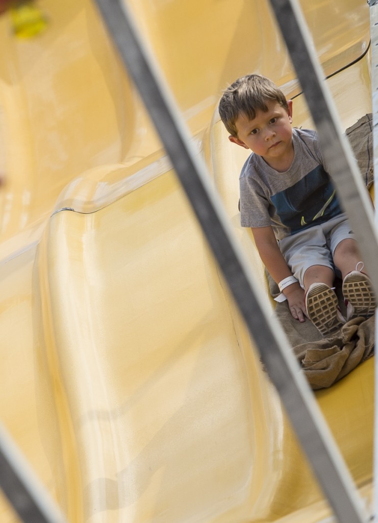 Tyler Wiggins, 4, of Jackson, Ohio, slides down the huge slide at the 2016 Wellston Coal Festival. (Robert McGraw/WOUB)