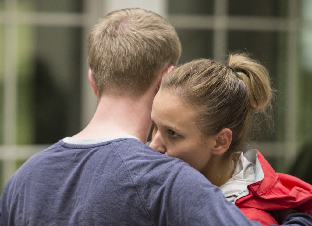 Jeremy Crump a 2nd year doctoral candidate (left) and his girlfriend Erika Stein  a grad student in the U.S. Coast Guard (right) embrace after they share their personal suicide stories during the 5th Annual Candlelight Vigil for Suicide Prevention. (Robert McGraw/WOUB)