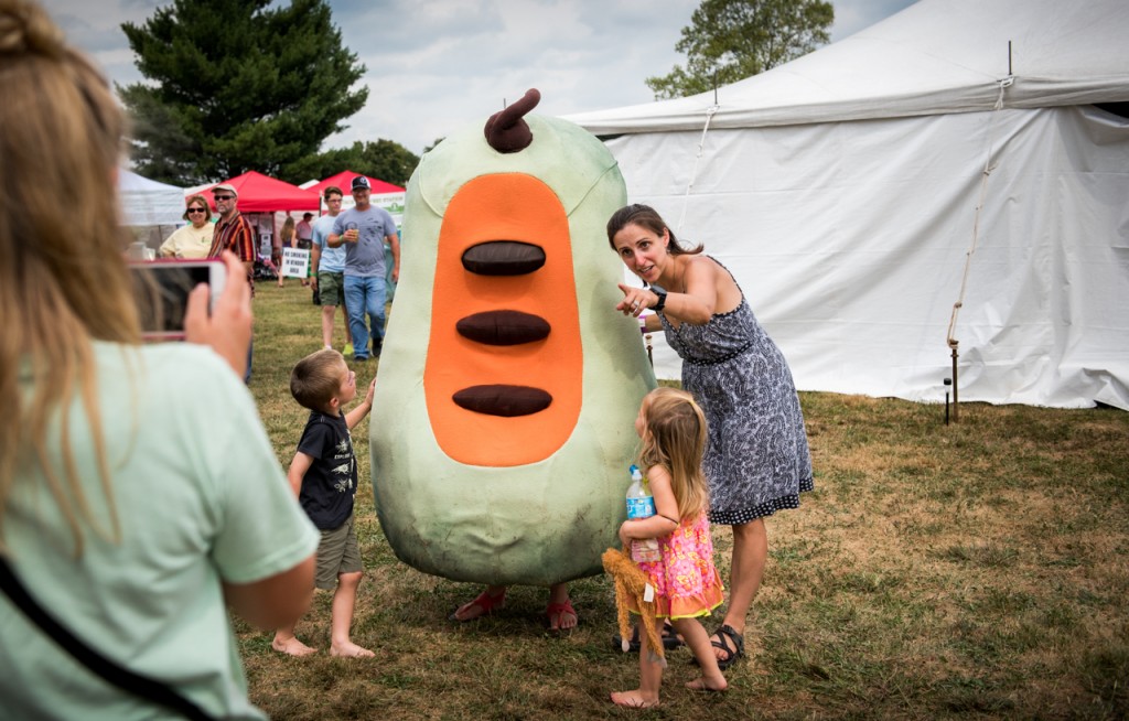 Ohio University alumnae, Jody Monk, trying to get her two children, Alden Monk (left), and Moxie Monk (right) to pose for a picture with the PawPaw mascot at the the Ohio PawPaw Festival in Albany, Ohio, September 18, 2016.