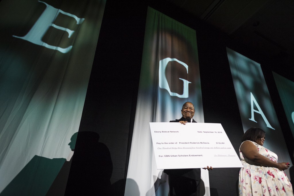 President Roderick J. McDavis holds up a check that was given for the EBN Urban Scholars Ednowment at the  Black Alumni Reunion Gala in the Baker Ballroom at Ohio University on September 16, 2016. (MICHAEL SWENSEN/WOUB)