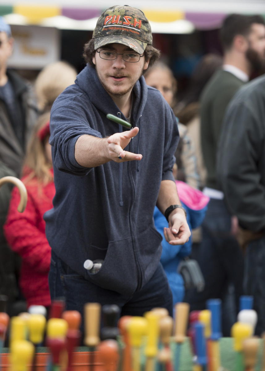 Ryan Chaffins from Amanda, Ohio, tries to win a prize at the ring toss on October 22, 2016, at the Circleville Pumpkin Show. (Robert McGraw/WOUB)