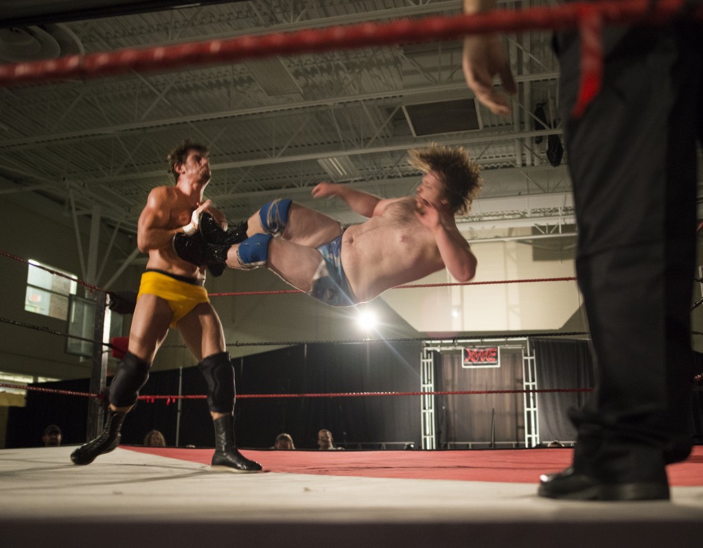 Bruce Grey, left, blocks a full body attack from Ben Blagg, “Duke Beefhammer,” during the first match of the Hocking College XWE Pro Wrestling even on Friday, October 21, 2016 in Nelsonville, Ohio. This is the fifth year that the event has been on the Hocking College campus. (Kelsey Brunner/WOUB)