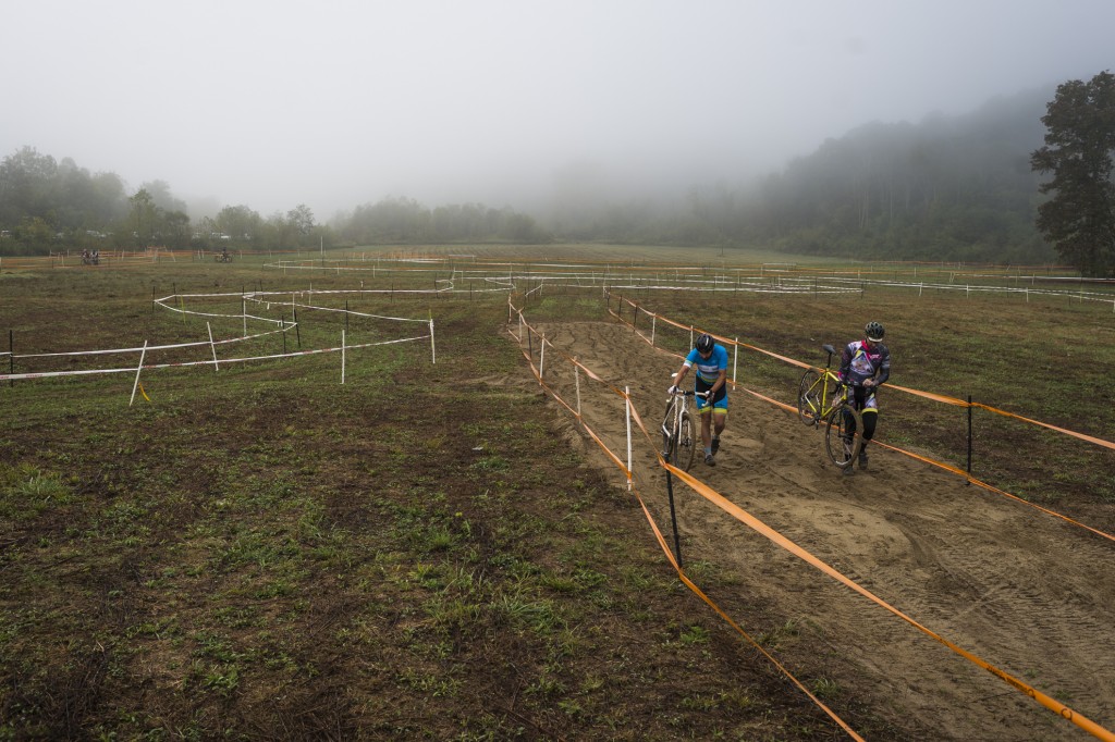 A couple of riders walk their bicycles over the sand trap section at the Hocking River Rumble on October 1, 2016. (Michael Swensen/WOUB)