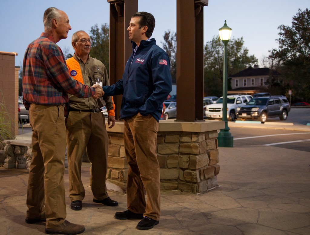 Don Trump Jr. greets Mike Brooks (left), former CEO of Rocky Brand, and Mike Budzik, Campaign Representative for Trump, in Nelsonville, Ohio on Monday, October 24, 2016. Trump Jr. stopped at Rocky Outdoor Gear Store, the largest business in Nelsonville, to meet local sportsmen and raise support for his father, presidential candidate Donal Trump. (Erin Clark/WOUB)