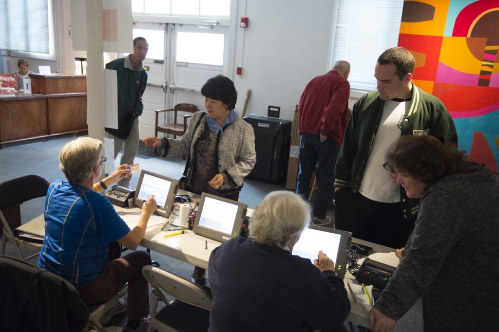 Athens residents present their IDs and line up to vote at the Dairy Barn Arts Center in Athens, Ohio, on November 8, 2016. (Robert McGraw/WOUB)