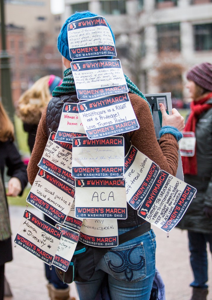 Julie Grawemeyer awaits for more messages to be pinned to her back at the Ohio Sister March on January 15, 2017 in Columbus, Ohio. Grawemeyer will then wear the messages at the National Women's March in Washington, D.C. next week to give a voice to fellow Ohioans who can not make it to the National March. (Erin Clark/WOUB)