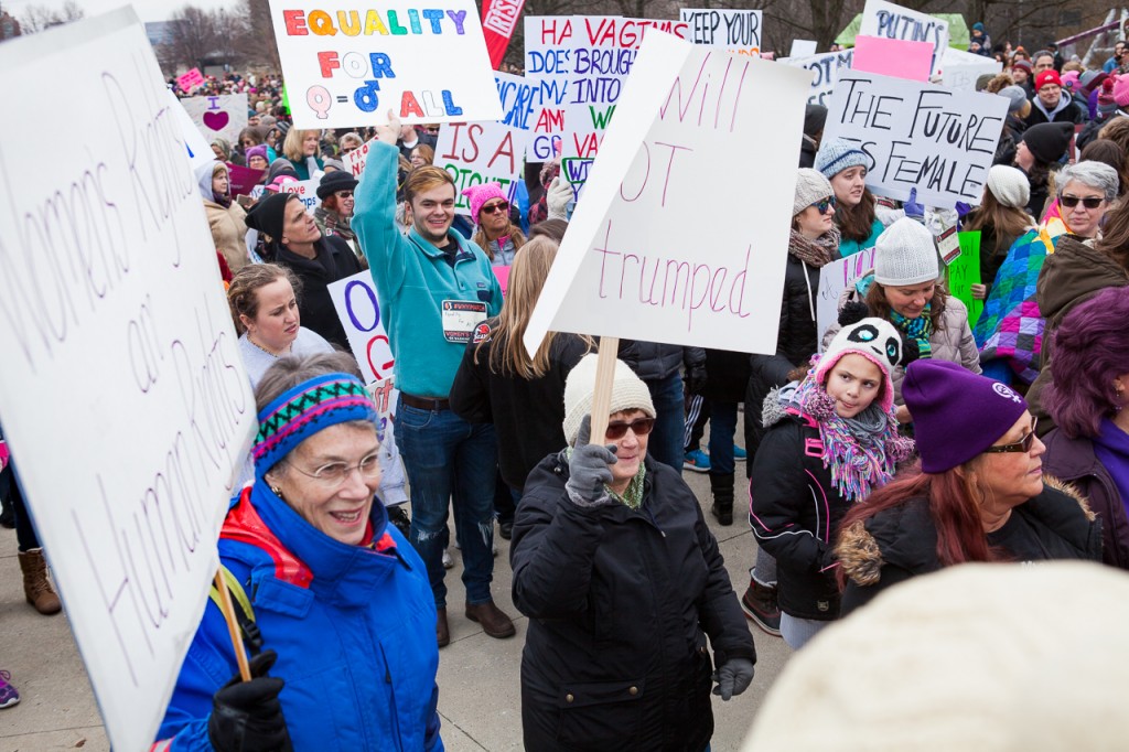 Marchers raise up their signs in excitement as they wait to march down Broad Street at  the WMW Ohio Sister March on January 15th, 2017 in Columbus, Ohio. (Erin Clark/WOUB)