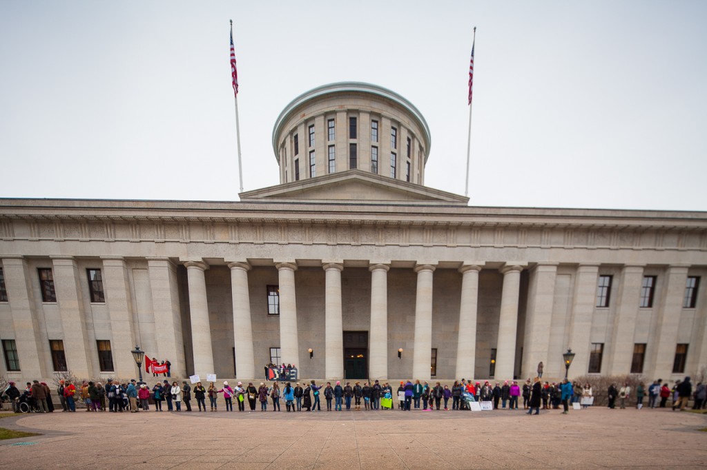 Marchers at the WMW Ohio Sister March take a moment of silence during The Circle the City with Love demonstration at the Ohio Statehouse on January 15, 2017. (Erin Clark/WOUB)