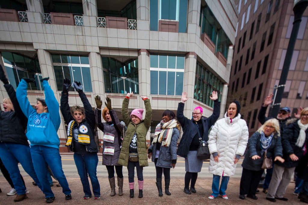 People attempt "The Wave" while demonstrating unity around the Statehouse of Ohio during the WMW Ohio Sister March in Columbus, Ohio on January 15, 2017. (Erin Clark/WOUB)