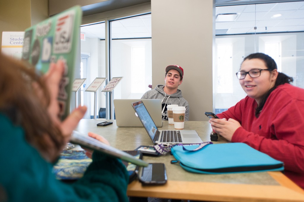 Jackson Baehr and Sarah Abrams look as Gabby Hollowell holds up her computer during the planning stage of Ad Club's annual Ad Bowl copmetition on Saturday, 28 January 2017 in Athens, Ohio. The three students form a team that has been assigned to advertise the Softsoap brand. (WOUB / Drake S. Withers)