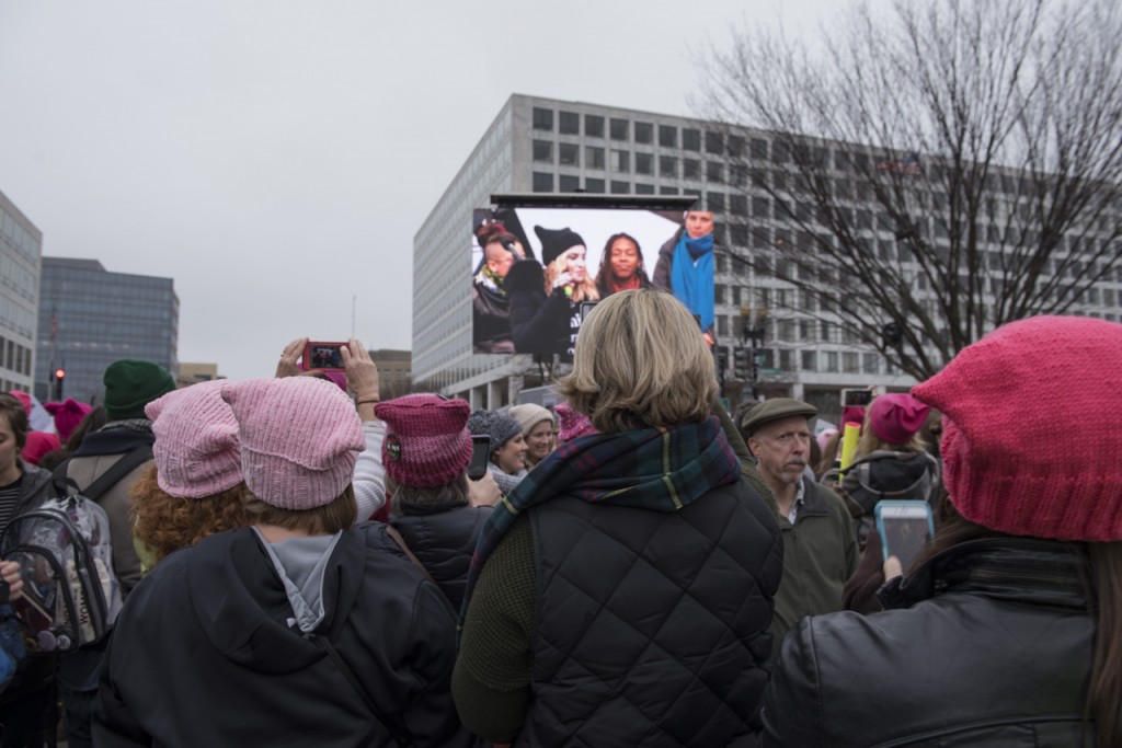 Hundreds of thousands participated at the WomenÕs March on Washington on January 21, 2017. Some attendees momentarily stop marching to view the large screen during MadonnaÕs speech  (Margo Sabec/WOUB)
