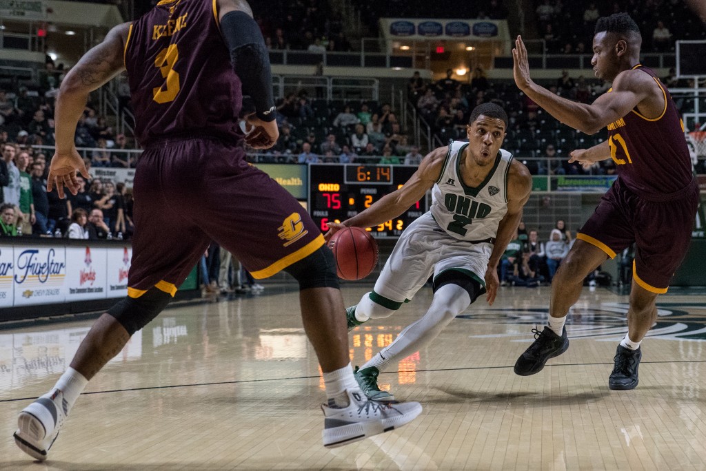 Ohio University point guard Jaaron Simmons (2) drives by Marcus Keene (3) and Cecil Williams (21). (Nickolas Oatley/WOUB)