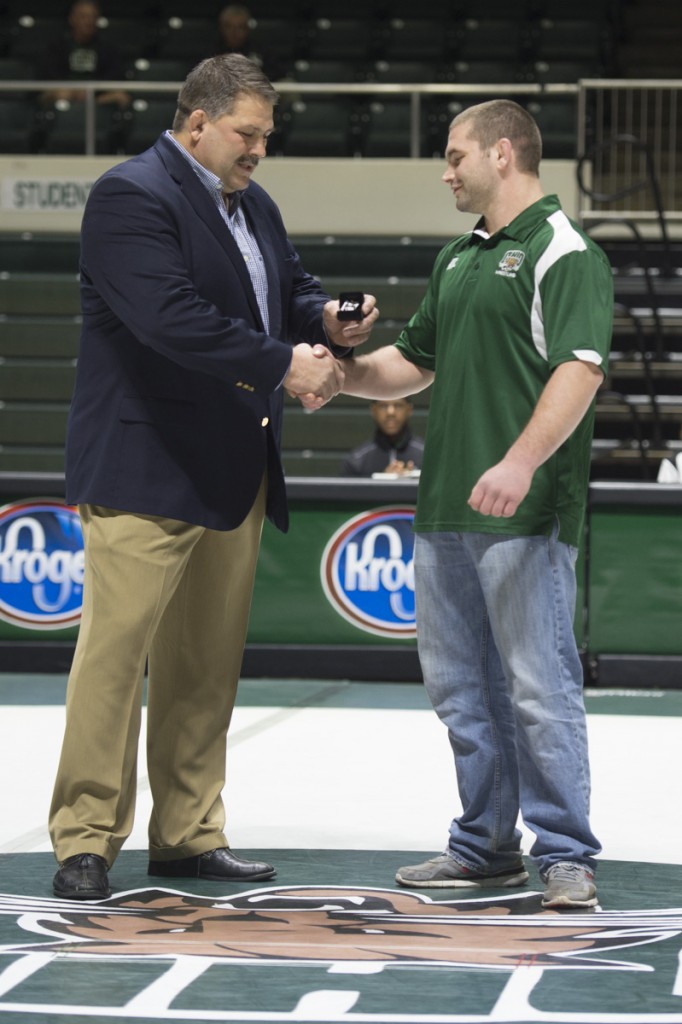 During Ohio University’s first Alumni weekend former wrestler Cody Walters receives an All-American ring during the halftime of the event from Coach Joel Greenlee. As a senior last year, he would place first during the MAC championships. (Robert McGraw/WOUB)