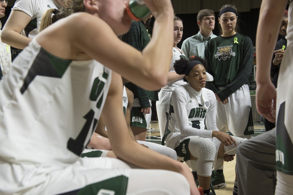 During a timeout, Quiera Lampkins is surrounded by teammates as they listen to strategies from the coaching staff. The Bobcats lost the game to Central Michigan 64-70 Wednesday night, February 15, 2017 at the Convocation Center. (Margo Sabec/WOUB)