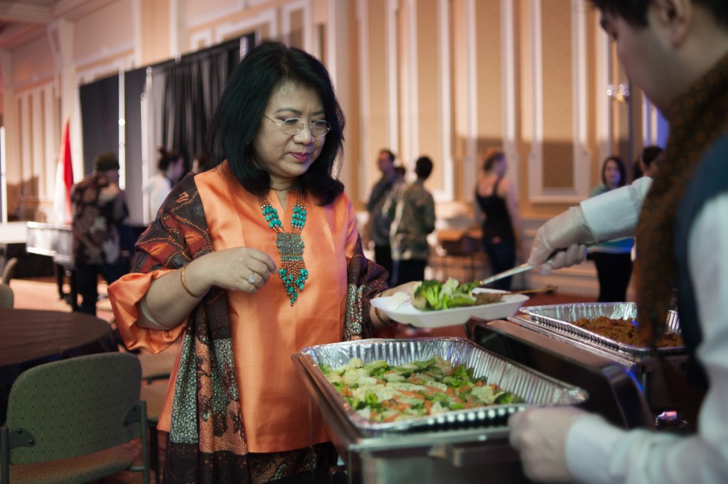 February 12, 2017—Athens, Ohio—Ima Rosmalawati Chalid, a guest of honor at Sunday's Indonesian Night, is served a dinner of traditional Indonesian food including peanut-sauce chicken, sautéed vegetables, and rice.
