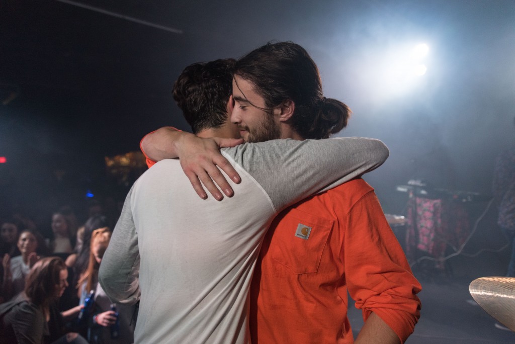 Max Reichert and Zak Blumer hugging on stage after their encore. (Nickolas Oatley/WOUB)