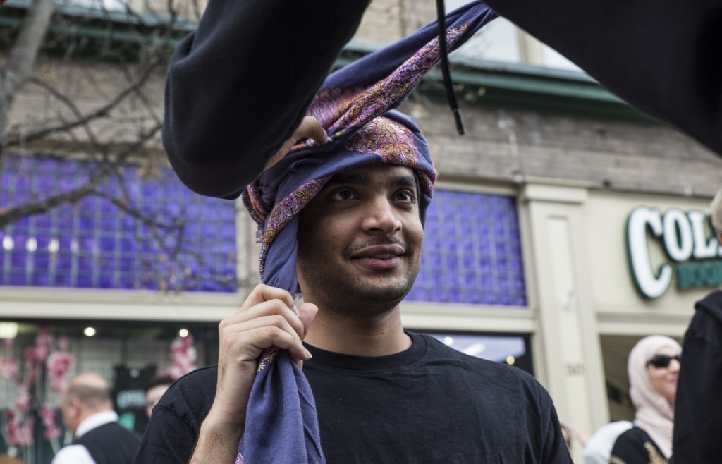 Prateek Kulkarni of India wears Omani traditional headwear Muzzar on the International Week Street Fair on the Court Street in Athens, Ohio, on April. 15, 2017. (Wangyuxuan Xu/WOUB)