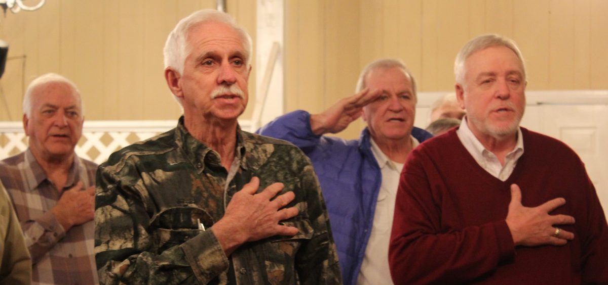 Retired miners begin a meeting with the pledge of allegiance.