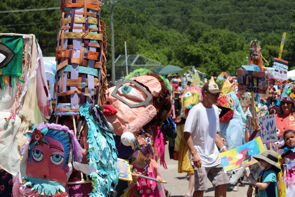 The Honey for the Heart parade makes it way through the grounds of the Nelsonville Music Festival. (WOUB/Marie Swartz)