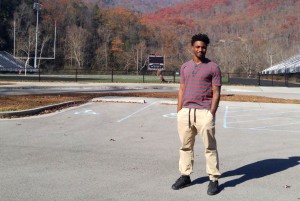 Derek Akal at the field where he played football in eastern Kentucky. (Benny Becker/ Ohio Valley ReSource)