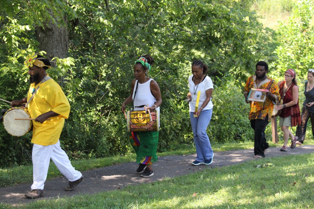 Those who took part in the parade around the Great Serpent Mound accompanied their movement with vocalizations and the playing various instruments. (WOUB/Emily Votaw) 